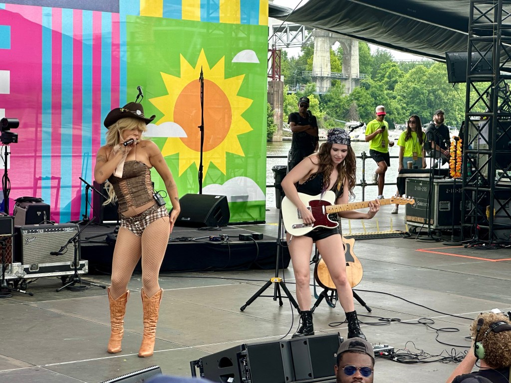 Tanner Addell singing with guitarist at Riverfront stage at CMAFEST