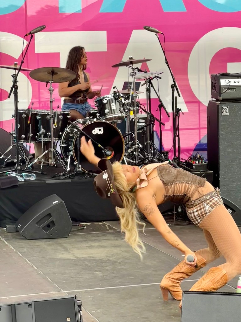 Tanner Addell dancing while drummer plays in background