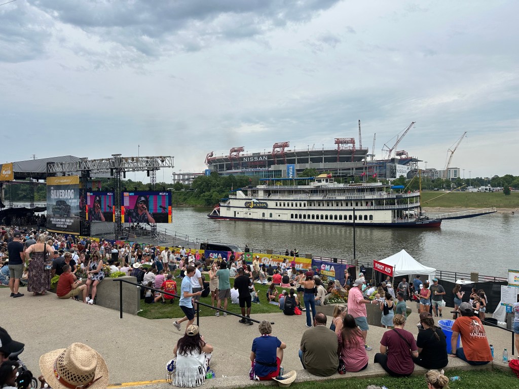 Riverboat on Cumberland River behind Riverfront Stage at CMA Fest 2025 with Nissan Stadium in background