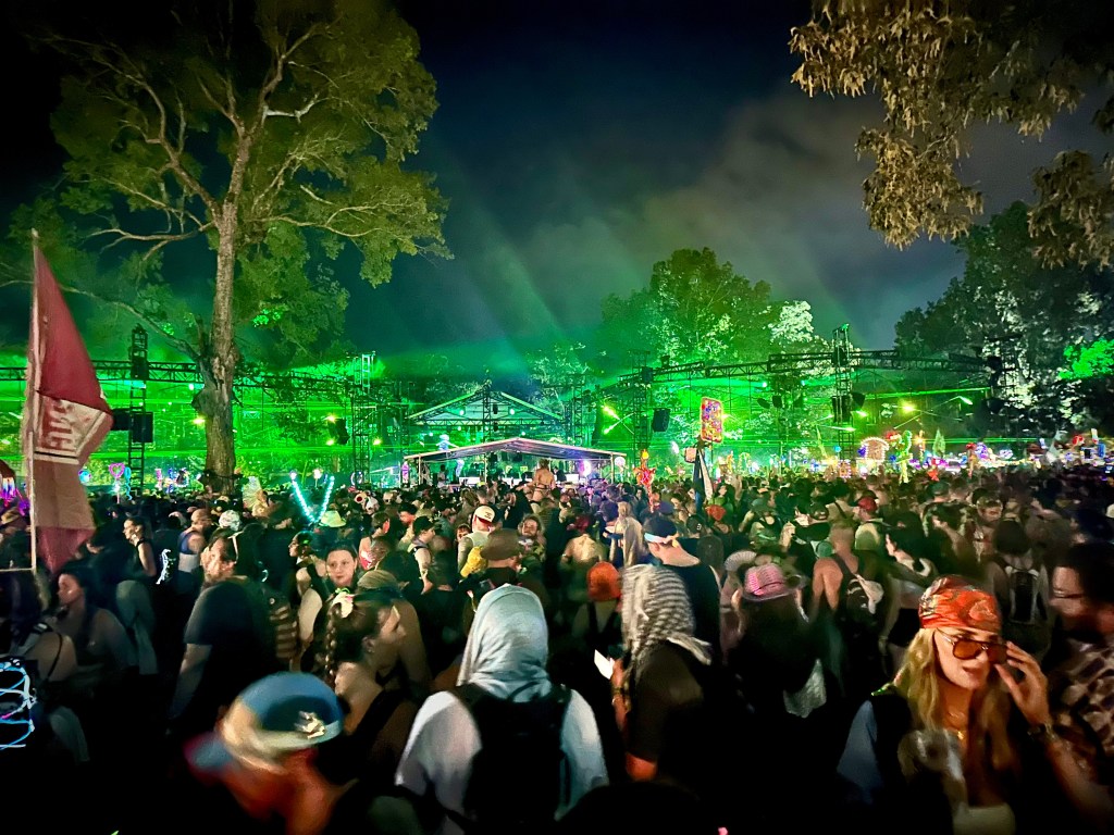 Looking across the crowd at the Infinity Stage as Of The Trees B2B Tap B performs at the 2025 Bonnaroo Music and Arts Festival