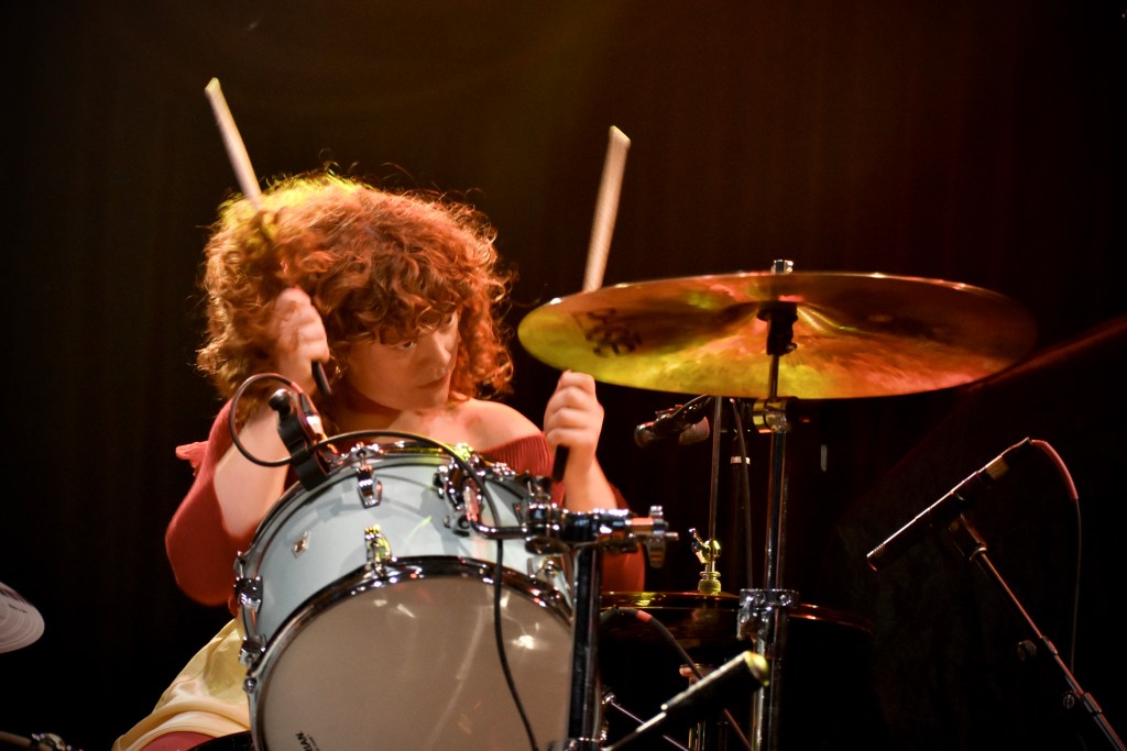 Laila from Girl Tones band drumming at Brooklyn Bowl concert in Nashville