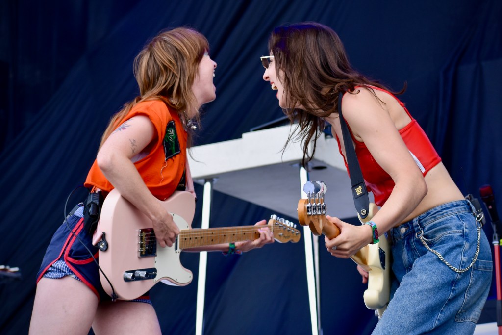 Scarlet Halton playing guitar with Orla Gartland at Hinterland Music Festival 2025