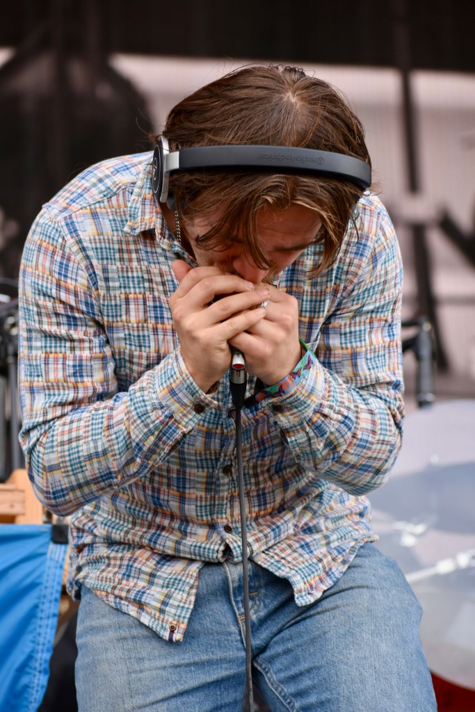Harmonica player performing with Wyatt Flores at Hinterland Music Festival