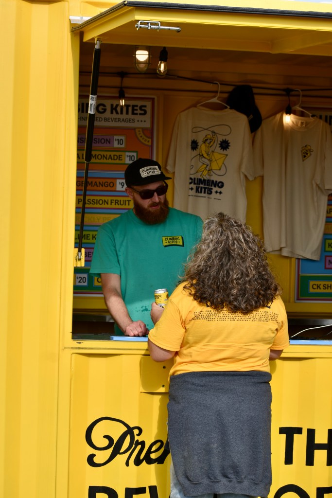 Music fan purchasing climbing kite beverage at Hinterland 2025