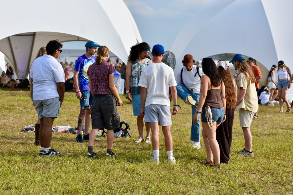 Group playing hacky sack between sets at Hinterland Music Festival 2025