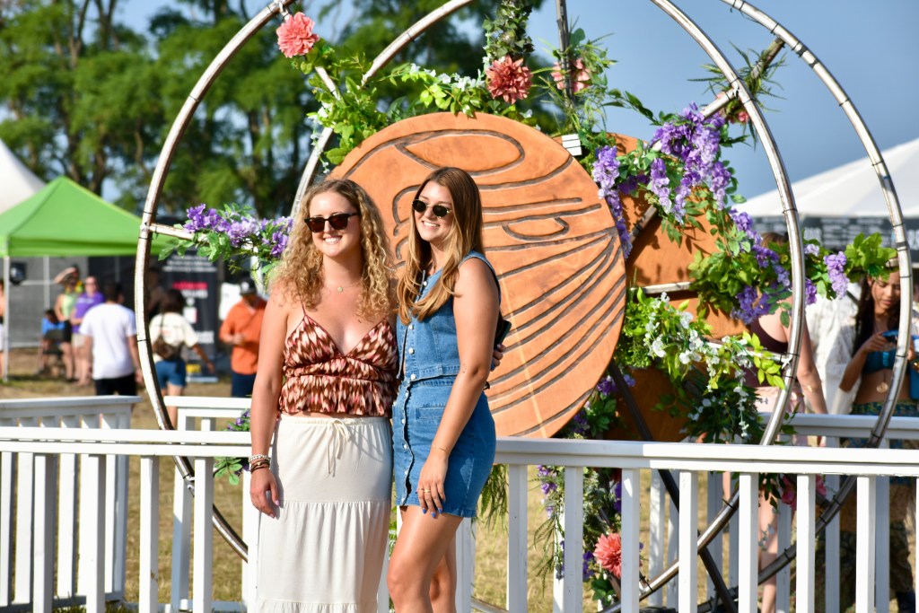 Two music fans posing for photo at with art at Hinterland Music Festival 2025