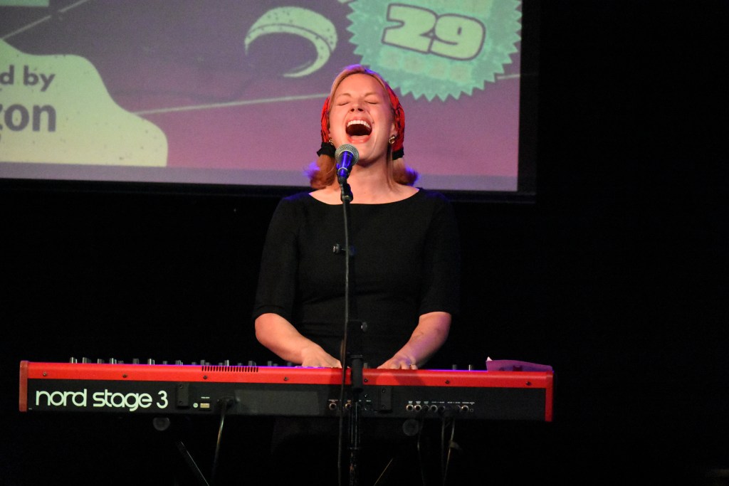 Ashe playing a keyboard and singing at 3rd and Lindsley in Nashville Tennessee